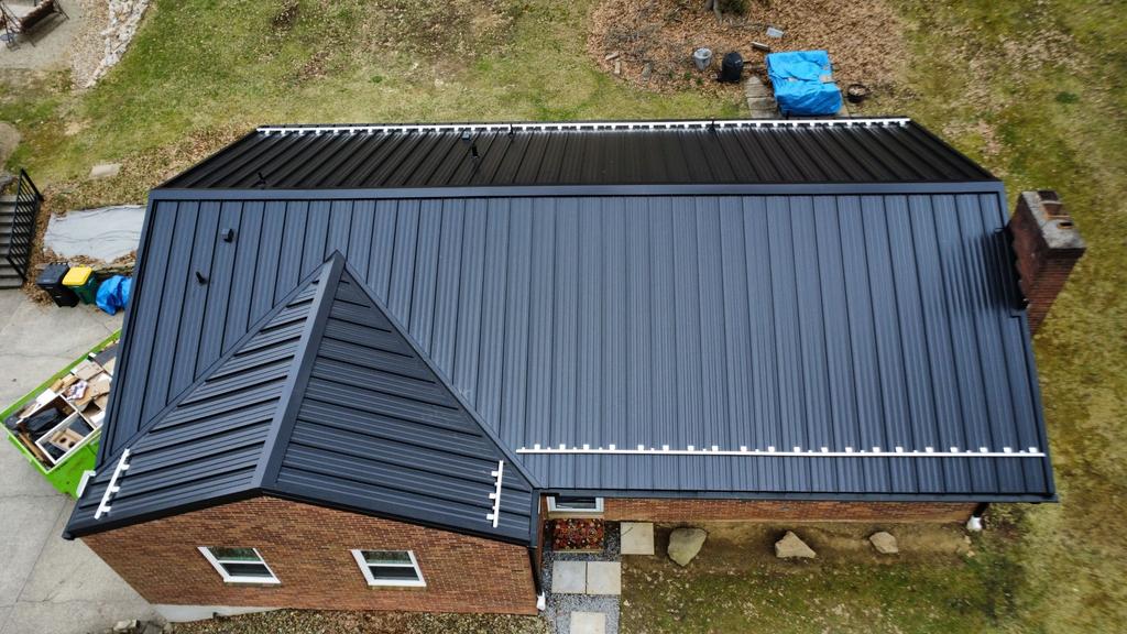 Black standing seam metal roof with multiple slopes