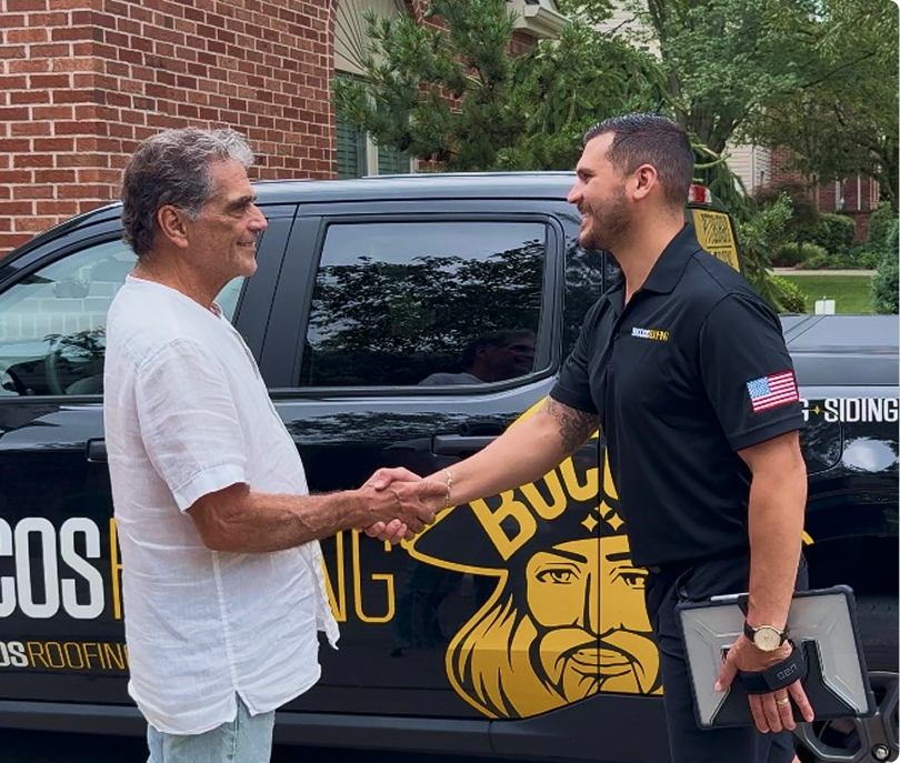 Buccos Roofing team with a homeowner