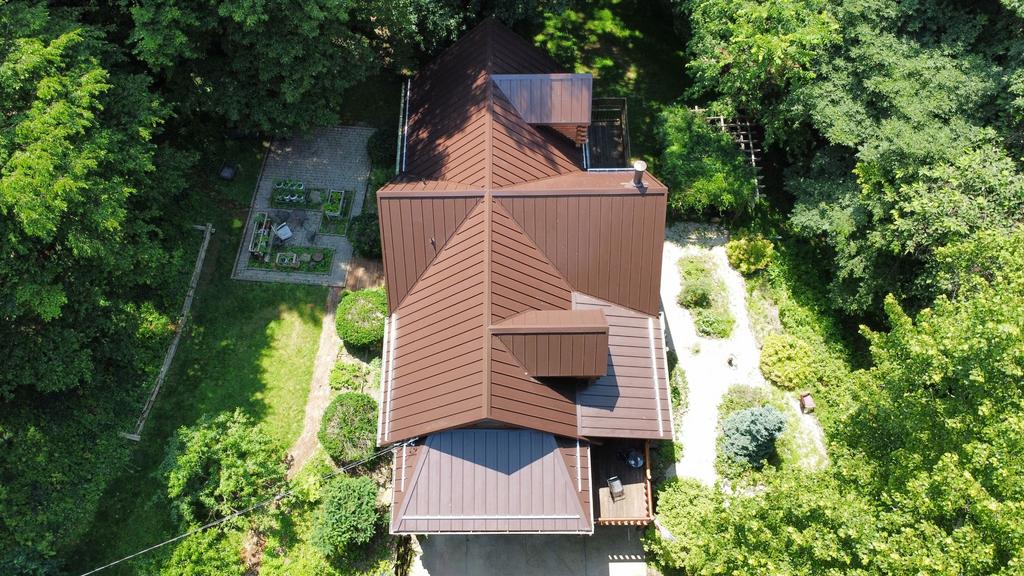 Brown mansard metal roof installation