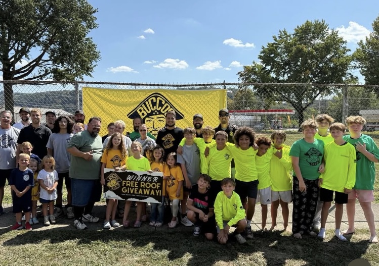 Community group photo from a previous Buccos Roofing giveaway event.